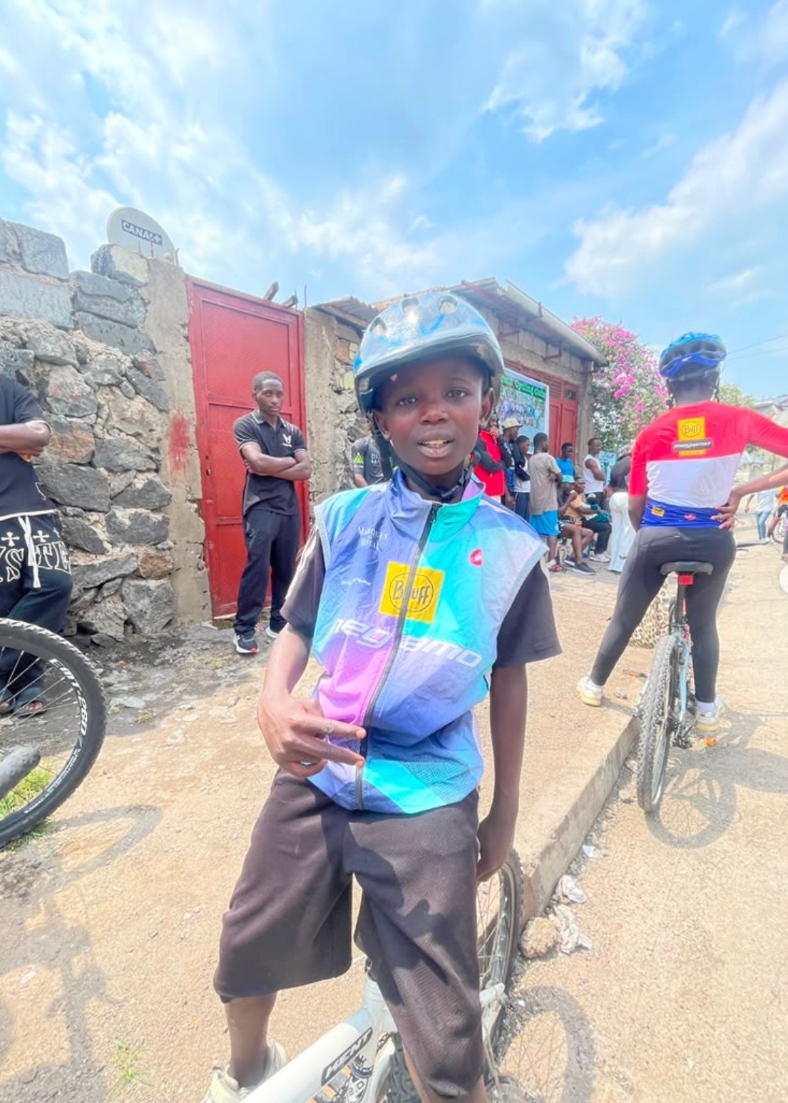 Tumaini cyclist wearing a helmet